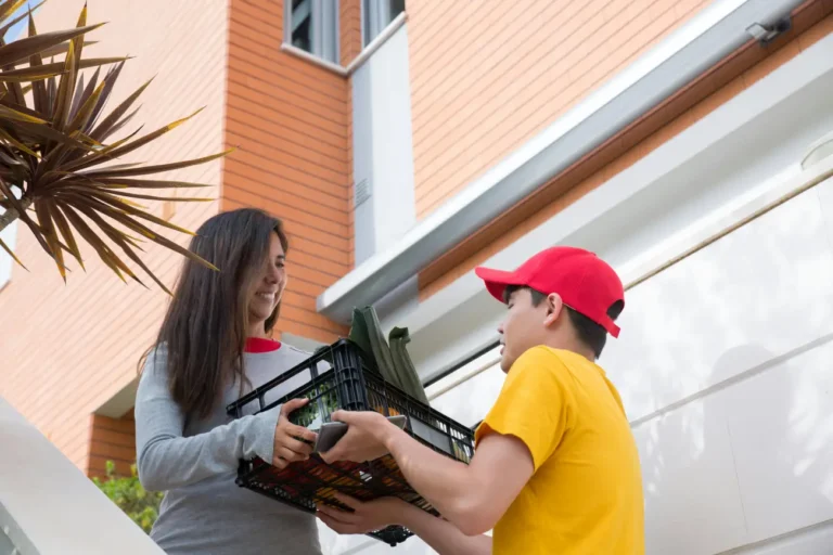 A Delivery Man Handing the Plastic Basket to the Woman