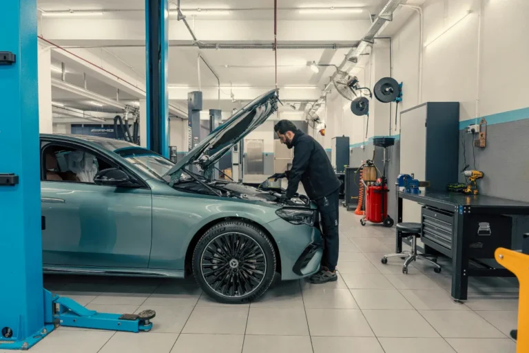 Mechanic Working on Luxury Car in Modern Garage